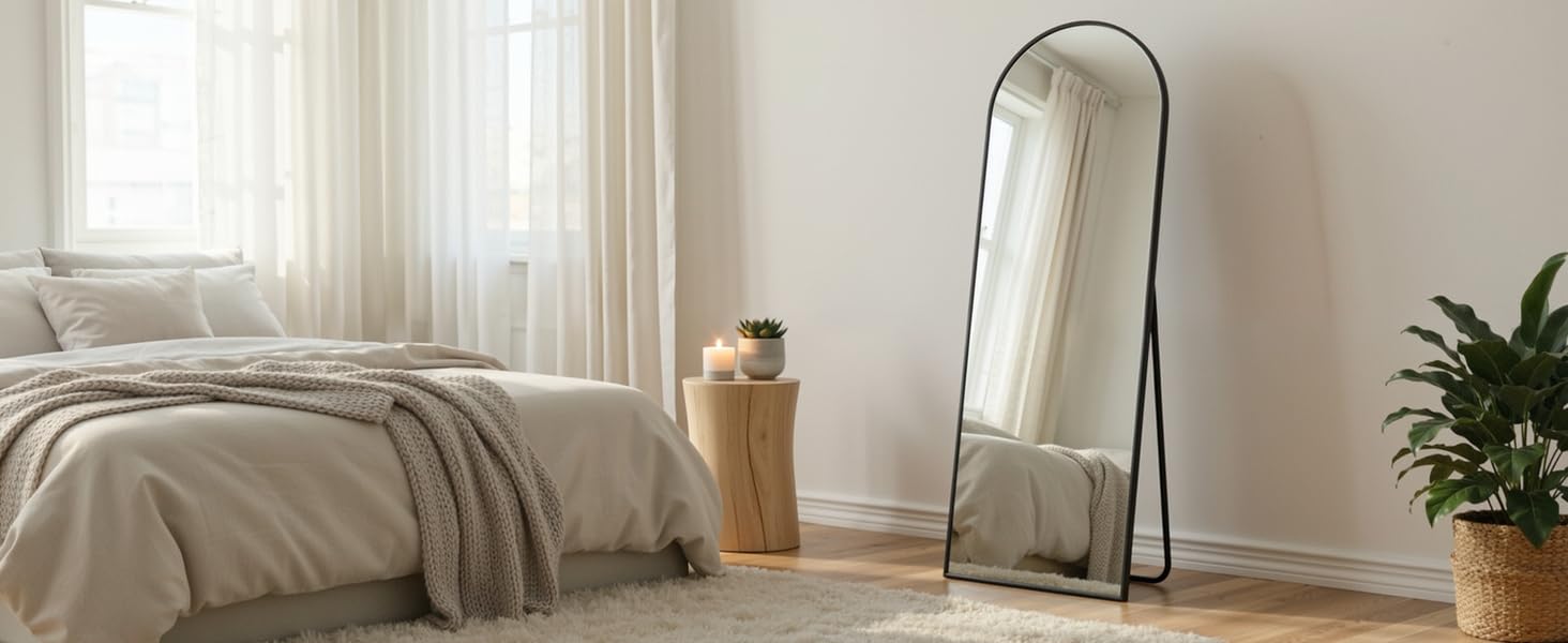 Minimalist interior room setting with white walls, hardwood flooring, and natural light coming through windows. Features simple furniture and clean lines.