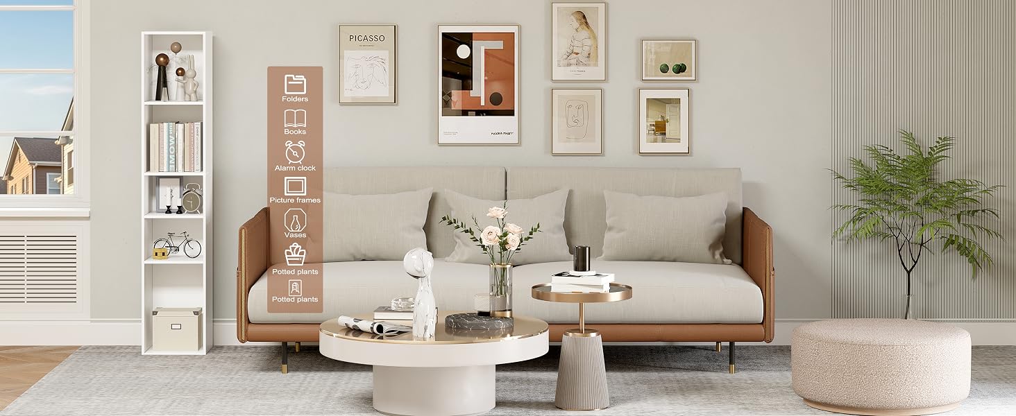 Modern living room with beige sofa, white coffee table, and decorative wall art. Includes bookshelf and floor lamp.