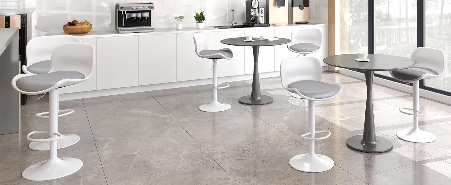 Modern commercial space with multiple round white tables and stools arranged on gray flooring, showing various angles of the same interior setup.