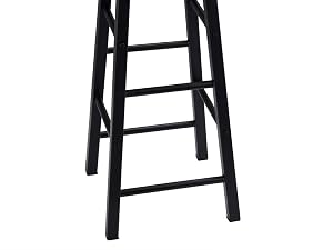 Tall bar stool with round wooden seat top and black metal frame featuring four supporting rungs.
