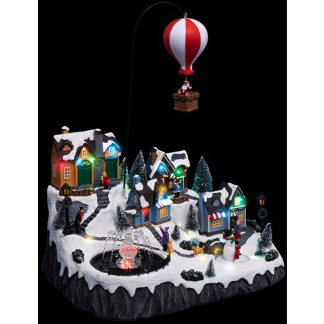 Fééric Lights And Christmas – Village de Noël lumineux animé musical avec 46 LED – Père Noël dans sa montgolfière – 40,5 cm – Poids 3,43 kg