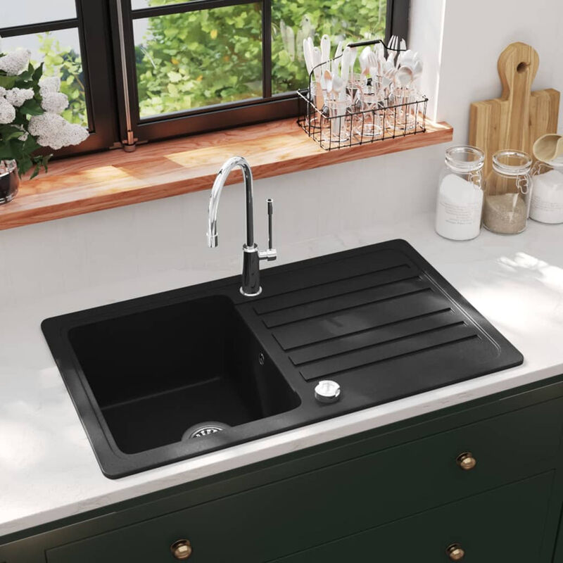 

Fregadero de cocina de granito con un seno y escurridor negro
