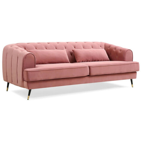 Un canapé en velours noir dans un appartement rose