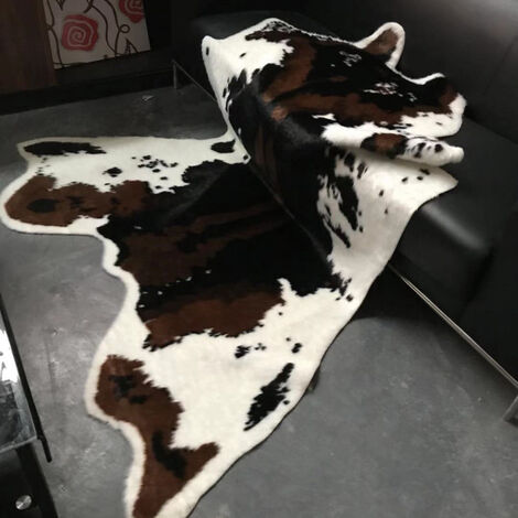 Un Salon Avec Une Cheminée Et Un Tapis Imprimé Vache