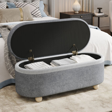 Banco con almacenaje, 110x41x47 cm, asiento tapizado en vellón gris, patas de madera, tapa abatible