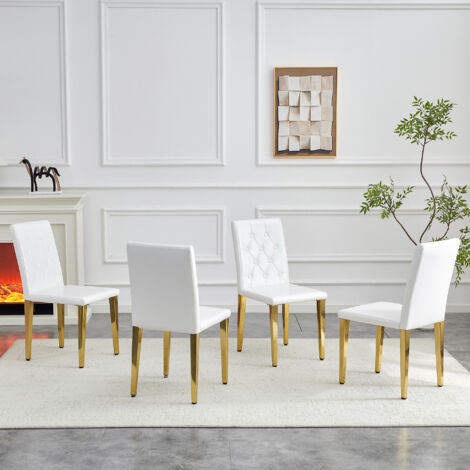 Juego de 4 sillas de comedor acolchadas, respaldo capitoné, patas de metal dorado, piel sintética blanca.