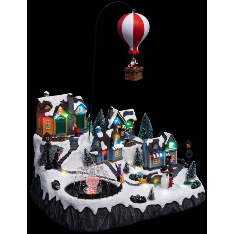 Fééric Lights And Christmas – Village de Noël lumineux animé musical avec 46 LED – Père Noël dans sa montgolfière – 40,5 cm – Poids 3,43 kg (1/3)