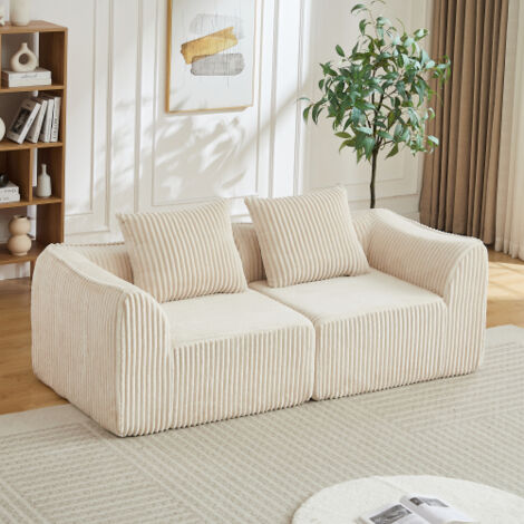 Canapé deux places, avec deux coussins, style épuré, tissu velours rayé, lignes fluides, dossier légèrement incliné, couleur blanc cassé