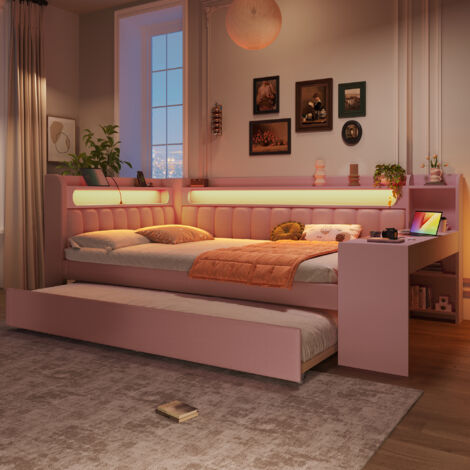 Lit de jour avec coussinage, dimensions 140x200. Il est équipé de ports USB et d’un éclairage LED. Le lit peut être converti en lit pliant, ainsi qu’en bureau. Couleur rose. (1/5)