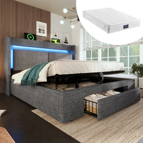 Lit en forme de lit Polster, de 140x200 cm. Il dispose d’un espace de rangement hydraulique, Il est équipé d’une lumière LED, ainsi que de prises USB et USB-C.gris. Matelas inclus. (1/5)