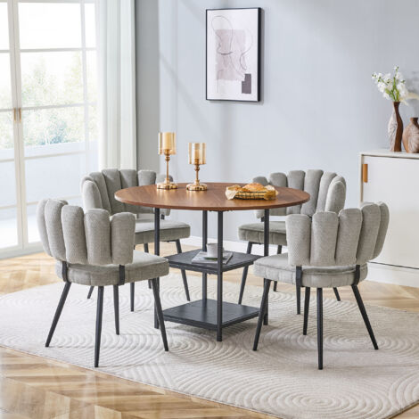Set de tables et chaises. Table de repas ronde, mesurant 107 cm, dans une finition en bois noir. Le set comprend également 4 chaises en tissu gris, avec d’épaules incurvées en forme de fleurs (1/5)