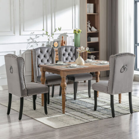 Set de 4 chaises de la salle à manger, avec pieds en bois. Chaise dotée d’un bouton, de poignées en chrome, et de têtes de clous.Couleur gris. (1/5)