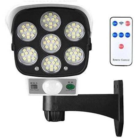 Lámpara solar para exteriores con sensor de movimiento inalámbrico y cámara de seguridad simulada. IP66, resistente al agua, 77 LED, foco de pared para patio, jardín, terraza, garaje y entrada. DEBUNS