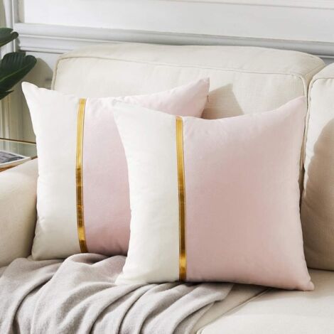 Lot de 2 housses de coussin décoratives 45 x 45 cm pour salon, canapé ou chambre, patchwork de velours rose poudré et blanc avec finitions en cuir doré, décoration intérieure moderne et luxueuse.