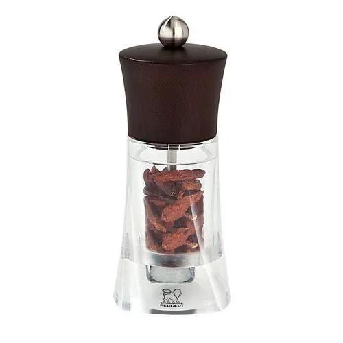 Designed for efficiently grinding dried chilli pepper, the Oléron chilli grinder offers plenty of heat and flavour to fire up your food and stimulate your senses. The transparent body evokes movement and plays subtly with light, in clever contrast with the earthy tones of chocolate beech wood.  Oléron