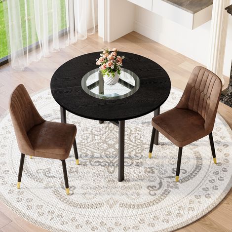 Table ronde 100cm effet bois noir. 2 fauteuils marron tissu tech pieds métal,chic discret pour salon moderne.