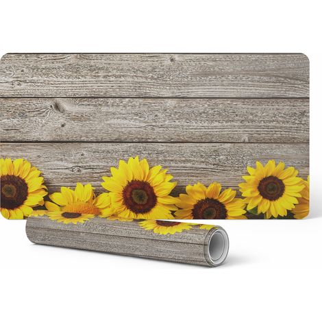 Alfombrilla de escritorio de vinilo con estampado de girasoles sobre fondo de madera, 90x45 cm.