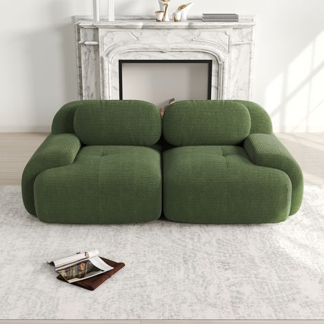 Ecksofa modular aus Cordstoff in Grün, rahmenlos, mit geschwungenen Armlehnen und rutschfester Unterseite