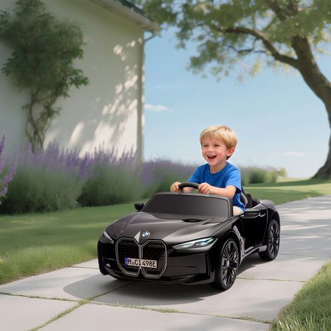 Auto elettrica per bambini BMW i4 12V con licenza ufficiale, telecomando, lettore MP3, musica, luci e cintura di sicurezza, 115x67x45 cm, nera.