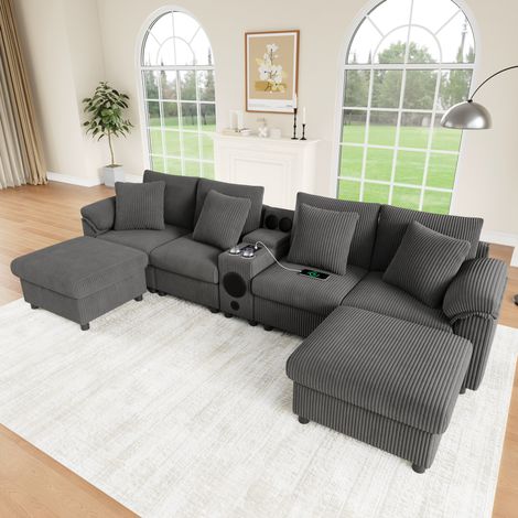 Divano modulare 315,5x144 cm grigio in velluto a coste con console multimediale, Bluetooth e pouf (1/5)