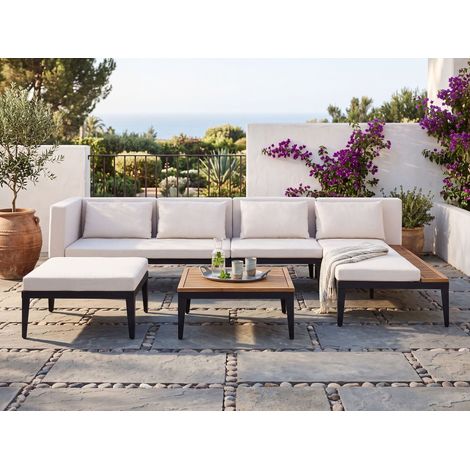 Conjunto de jardín 4 plazas de madera de acacia certificada sofá esquinero con mesa de centro y otomana cojines beige claro izquierdo Bracciano (1/5)
