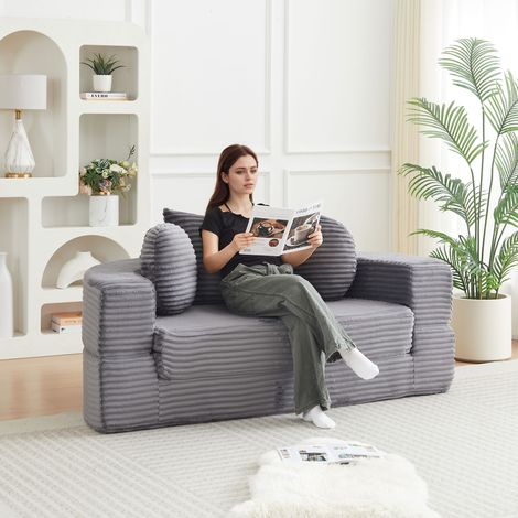 Un canapé-lit 4 en 1 polyvalent, idéal pour les petits espaces, qui peut servir à la fois de canapé semi-circulaire et de méridienne ronde. Comprend deux coussins ronds et un coussin carré. (1/5)