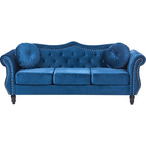 Sofá 3 plazas tapizado en terciopelo azul botones de adorno apoyabrazos enrollados estilo glam Skien