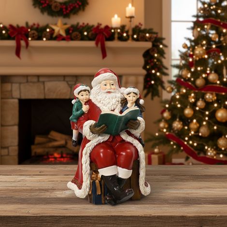 Statuetta decorativa di Babbo natale seduto con libro, da h 18 cm (1/4)