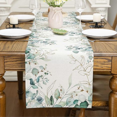 Chemin de table printanier. Décorations printanières : feuilles d'eucalyptus blanc cassé, table verte. (1/4)