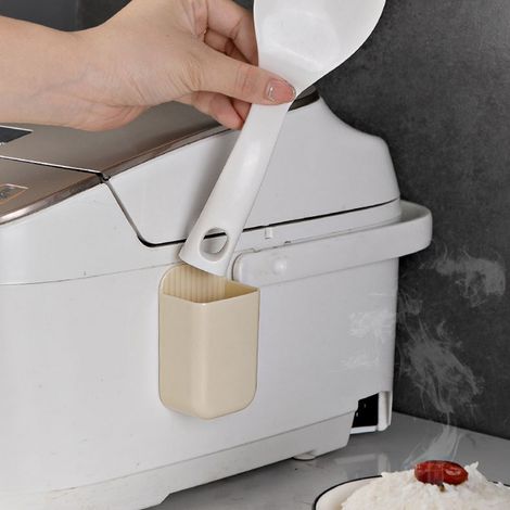Support mural en plastique pour spatule à riz, idéal pour la cuisine.