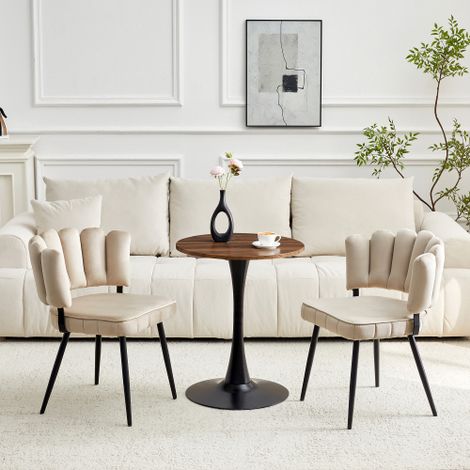 Ensemble table et chaises. Table ronde de 60 cm en MDF avec pied de support noir, accompagnée de deux chaises de salle à manger dotées d'un dossier en velours à motif pétales et de pieds en métal noir