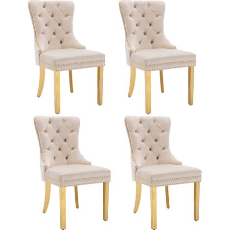 Silla de comedor tapizada en terciopelo beige con respaldo decorativo y patas doradas (1/5)