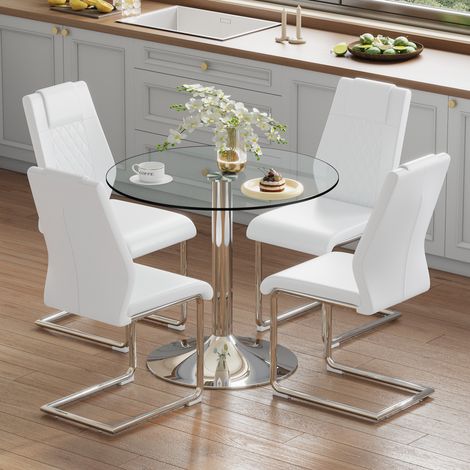 Table ronde verre 85cm avec 4 chaises pieds métal argenté et assises PU blanches,design moderne pour aménagement intérieur.