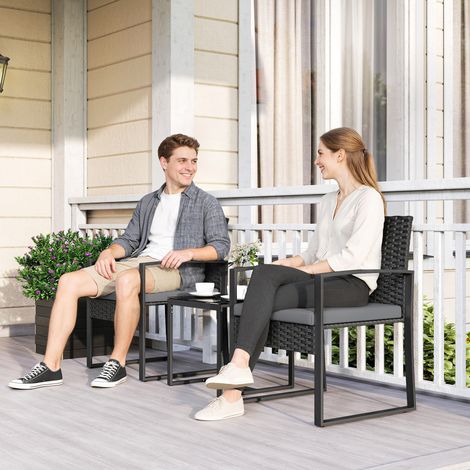 Set di mobili da giardino in rattan sintetico con 2 sedie con cuscini sfoderabili e tavolo con piano in vetro grigio.