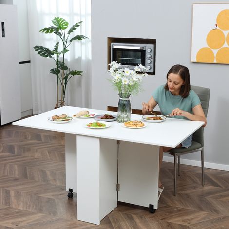Table Pliante 6 Places, Bureau Repliable Blanc Économe 140x75x74cm avec 2 Étagères Ouvertes et Roulettes Freinées, pour Cuisine, Salon ou Bureau (1/5)