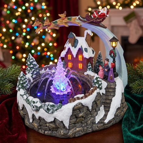 Scène lumineuse avec Père Noël et fontaine d'eau