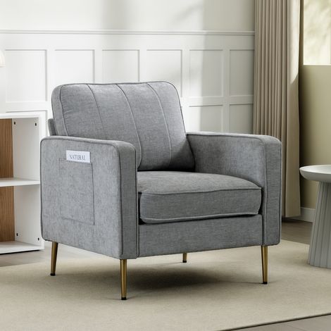Fauteuil gris en tissu moelleux, piètement doré en acier, assise confortable, poches de rangement latérales, parfait pour séjour, chambre ou bureau