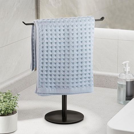 Porte-serviettes noir à base ronde, 27 cm de large et 30 cm de haut, conçu pour le rangement sur un comptoir de salle de bain en acier inoxydable. (1/5)
