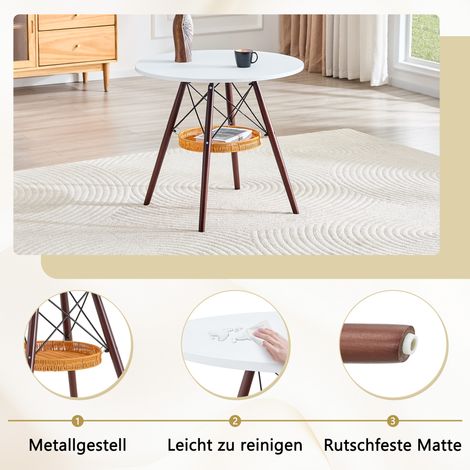 Table ronde Ø 80 cm, plateau en MDF blanc, pieds en bois massif noyer, avec panier suspendu tressé, idéale pour 2 à 4 personnes. (1/5)