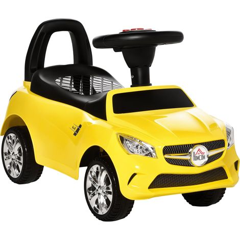 Voiture électrique pour enfant avec volant, phares et musique intégrée, en polypropylène et métal, 63,5 x 28 x 36 cm, jaune (1/5)