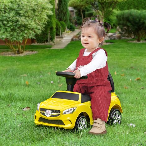 Coche de juguete infantil con volante, faros y música incorporada, fabricado en PP y metal, 63,5 x 28 x 36 cm, color amarillo. (1/5)