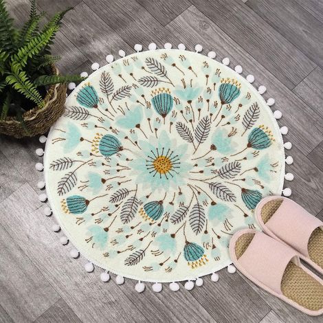 Ein schöner runder 60-cm-Badeteppich mit farbigen Pompons und Blumen-, Doppel- und Antidérapant-Motiven. (1/5)