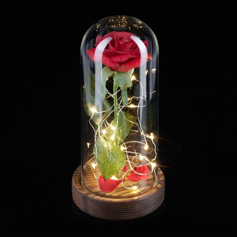 Rosa eterna en copa con vela