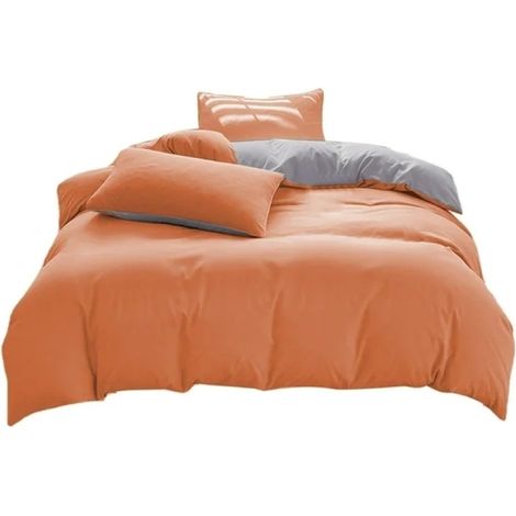 Un ensemble de literie quatre pièces bicolore à blocs de couleur, orange et gris, comprenant une housse de couette (200x230 cm), un drap (230x230 cm) et deux taies d'oreiller (48x74 cm) (1/5)
