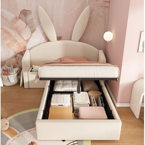 Lit enfant rembourré style lapin en velours beige 90x200 cm avec tête de lit enveloppante, coffre hydraulique et table de chevet