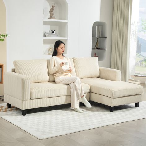 Divano angolare a tre posti in velluto a coste con chaise longue e cuscino a molle spesso, largo 214 cm, beige.