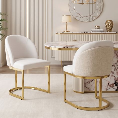 Dos sillas de comedor con respaldo doble, estructura estable, asiento de chenilla beige y patas de metal dorado. (1/5)