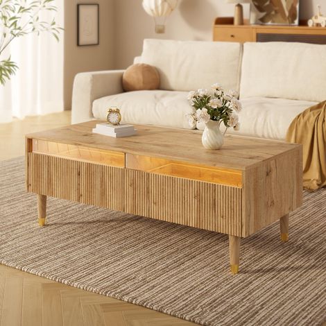 Cette table basse moderne à LED est dotée d'un plateau à tiroirs ondulé, de pieds dorés, de deux tiroirs et d'une bande lumineuse LED à couleurs changeantes. (1/5)