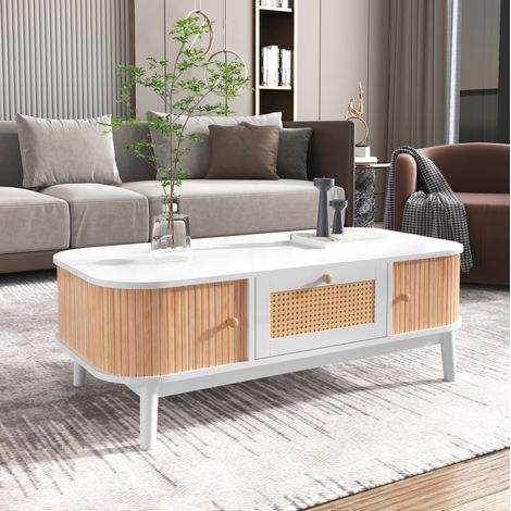 Table basse 110 x 55 x 38,5 cm en MDF blanc et bois, avec tiroirs en résine tressée, portes coulissantes, rangement et pieds en bois pour salon – de FLORAGRACE (1/5)