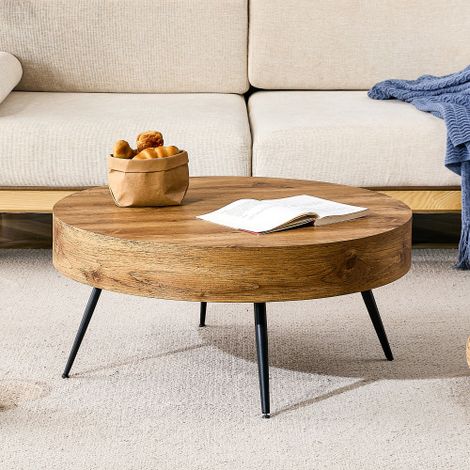 Une table basse ronde dotée d'une finition imitation bois (MDF) et associée à des pieds en métal noir. Grâce à son design minimaliste, elle constitue un choix idéal pour les salons et les petits espac (1/5)
